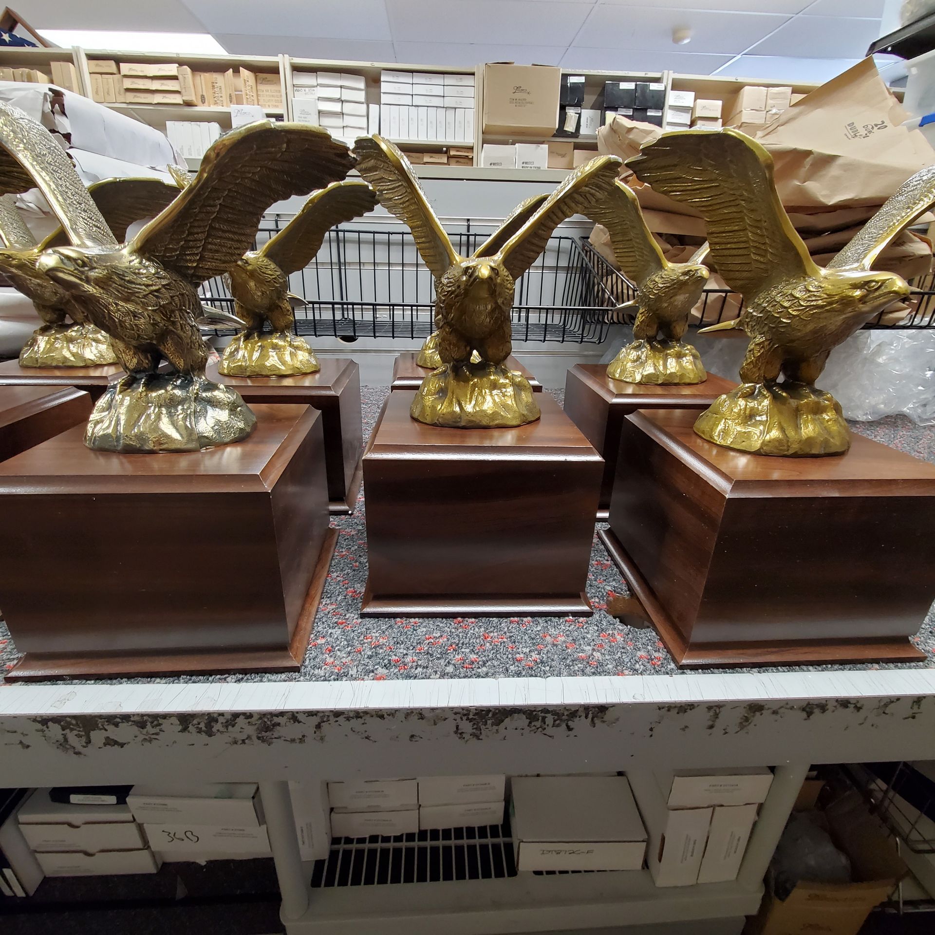 A bunch of eagle statues are sitting on a table