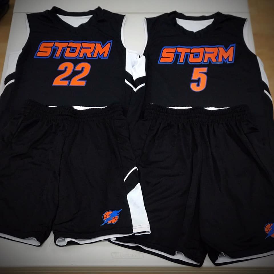 Two black storm jerseys and shorts on a table