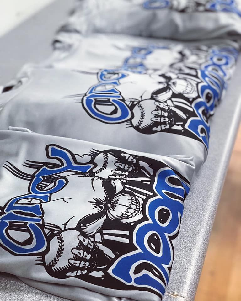 A row of shirts with skulls and the word boom on them