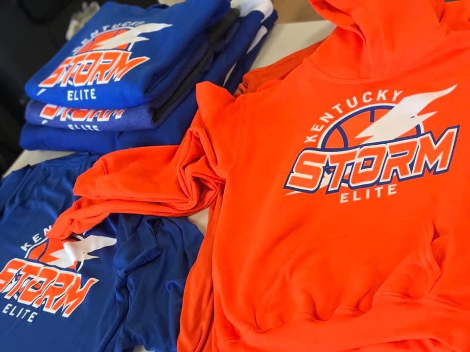 A stack of kentucky storm elite shirts and hoodies
