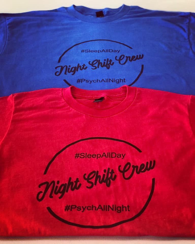 Two night shift crew shirts are stacked on top of each other