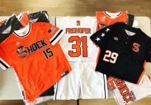 A bunch of shock jerseys are on a table