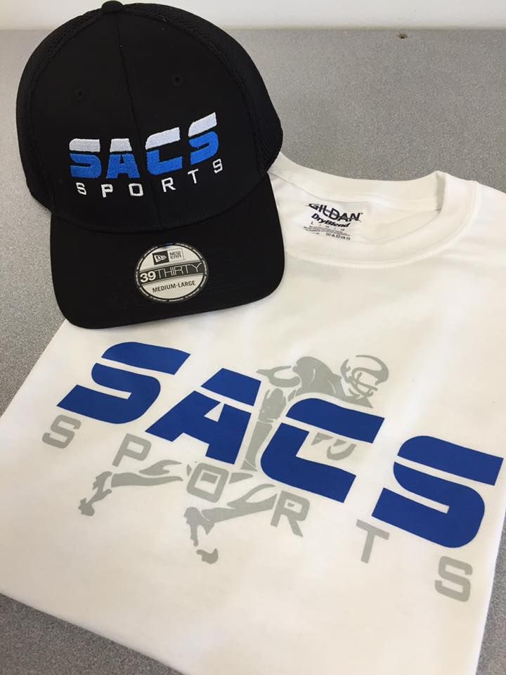 A black sacs sports hat sits next to a white t-shirt