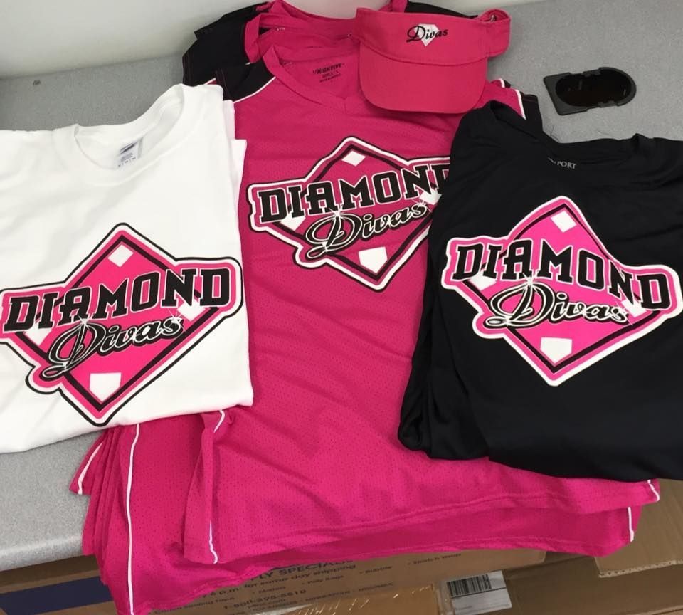 A stack of diamond divas t-shirts on a table
