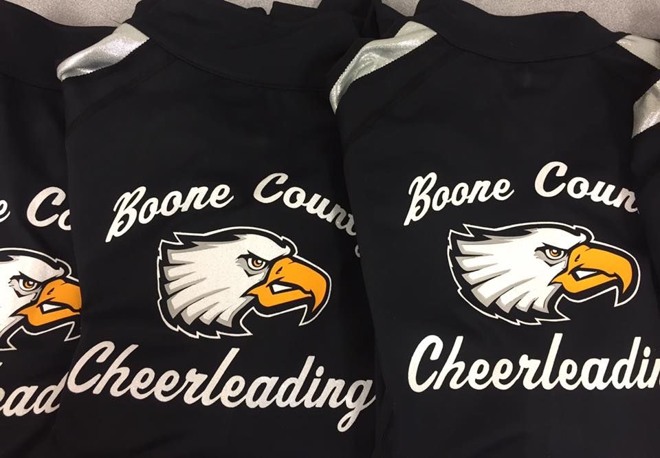 A row of cheerleading shirts with eagles on them