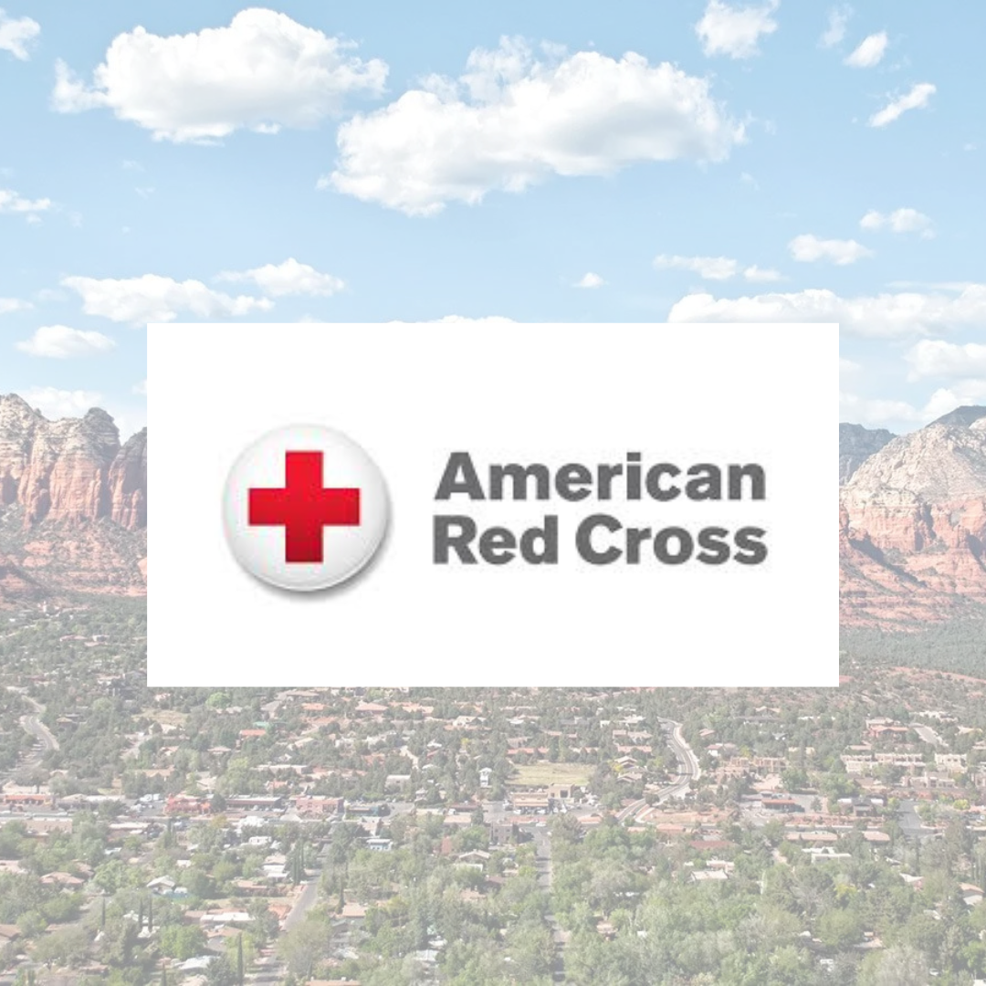 An american red cross logo with mountains in the background