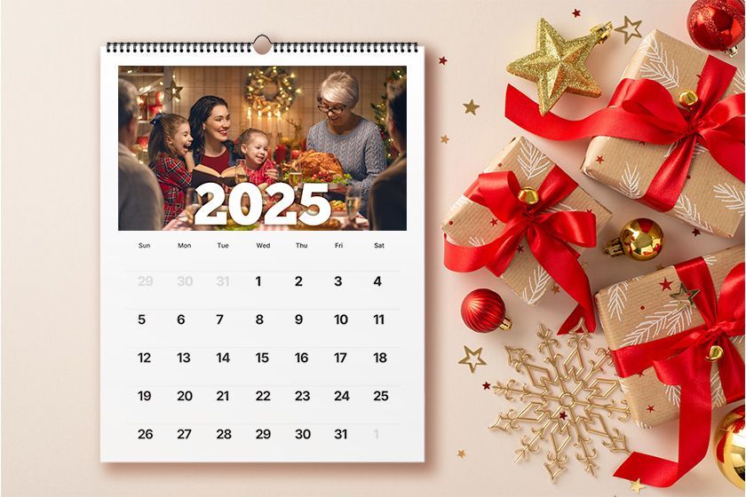 A calendar with flowers on a wooden table