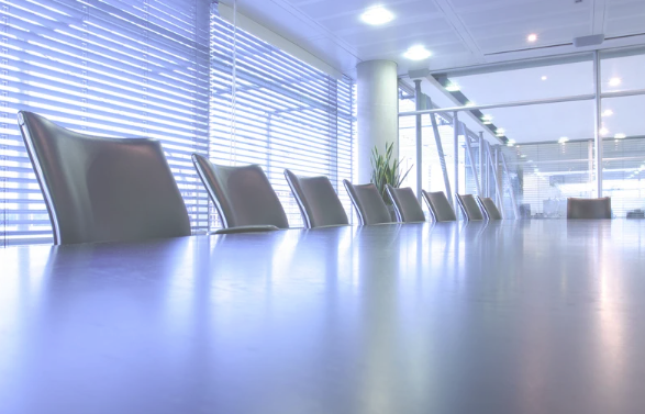 A blue couch is sitting in a living room next to a white wall.