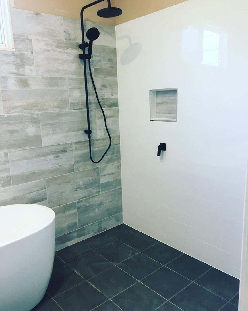 A Bathroom With A Bathtub And A Shower — Custom Design Bathroom Renovations in Port Macquarie, NSW