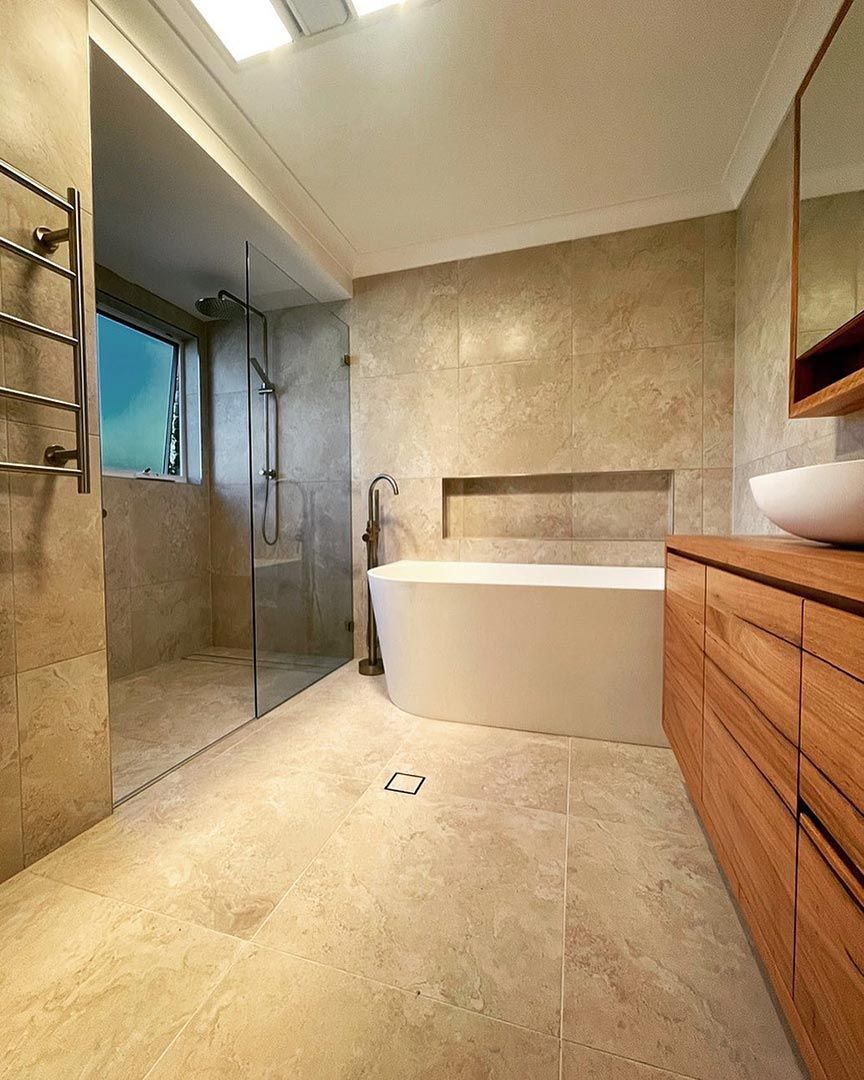 A Bathroom With A Bathtub, Sink, And Shower — Custom Design Bathroom Renovations in Port Macquarie, NSW