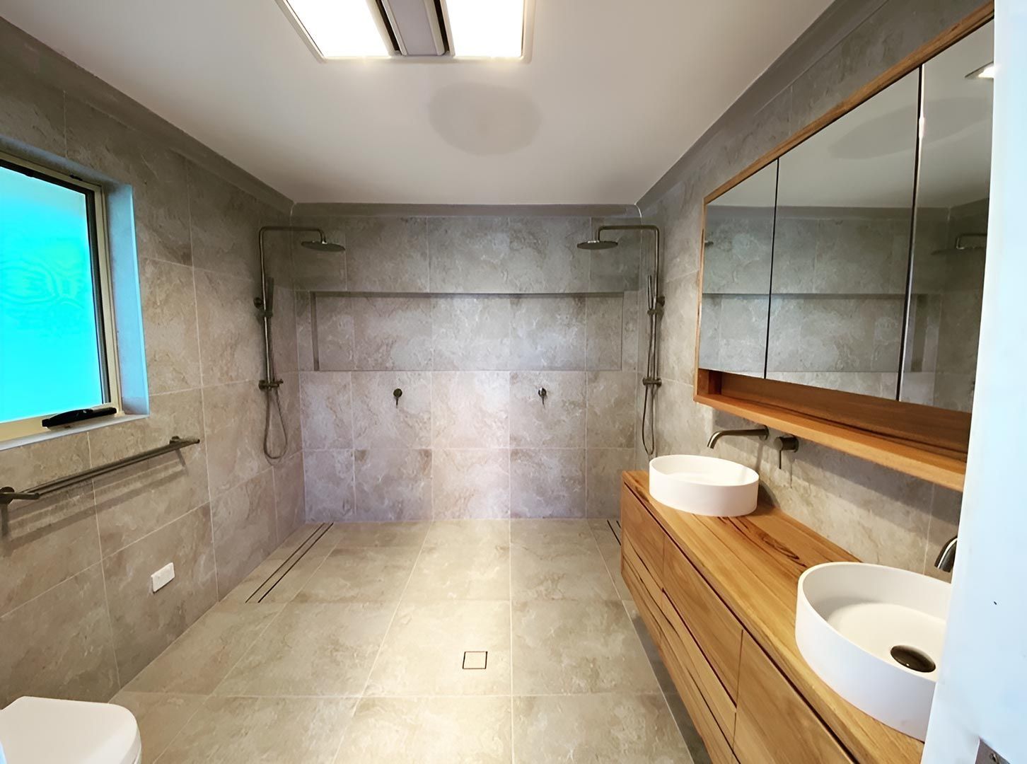 A Bathroom With Two Sinks, A Toilet And A Shower — Custom Design Bathroom Renovations in Port Macquarie, NSW