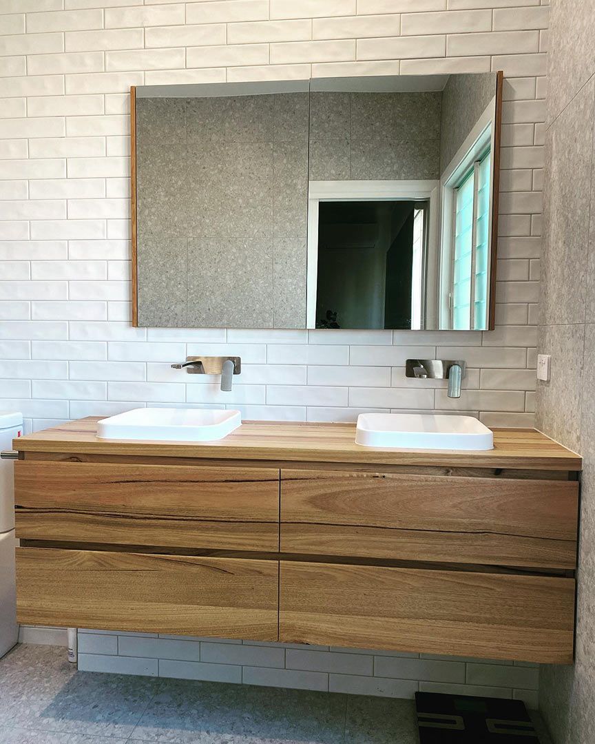 A Bathroom With Two Sinks, A Mirror And A Wooden Vanity — Custom Design Bathroom Renovations in Port Macquarie, NSW