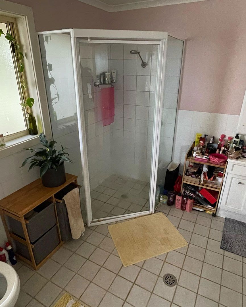 A Bathroom With A Shower, Toilet, Sink And Window — Custom Design Bathroom Renovations in Port Macquarie, NSW