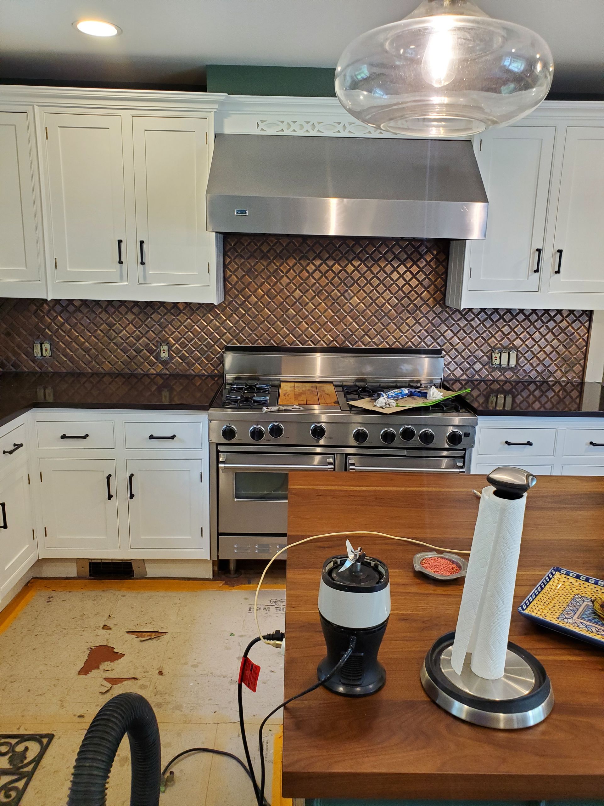 A kitchen with stainless steel appliances and white cabinets