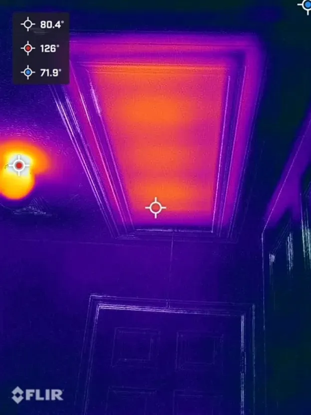 A thermal image of a hallway with a ceiling that is purple and orange.