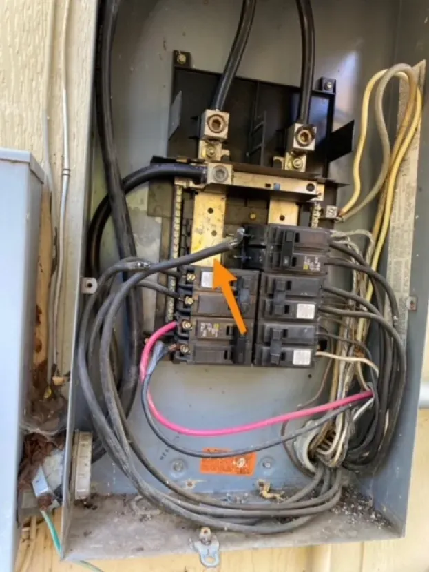 A close up of an electrical box with a lot of wires coming out of it.