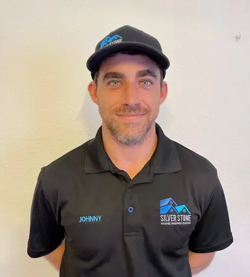 A man wearing a black shirt with the name johnny on it