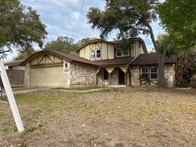 A house with a for sale sign in front of it