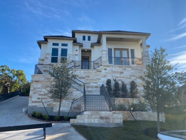 A large house with stairs leading up to it