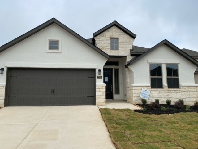 The front of a house with a for sale sign in front of it