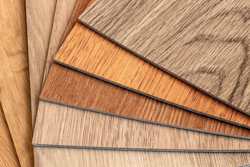 Close-Up of A Fan of Wood Flooring Samples in Various Shades of Brown — Express Timber Solutions In Long Jetty, NSW