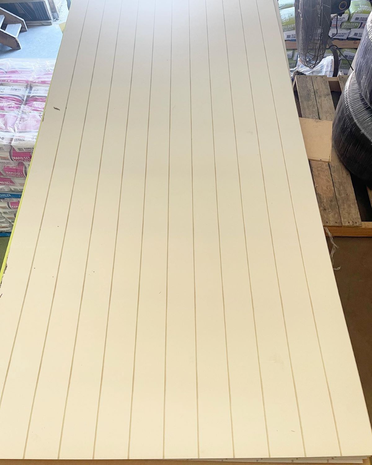 White Panel Marked with Vertical Lines, Likely for Cutting, Resting Outdoors — Express Timber Solutions In Long Jetty, NSW