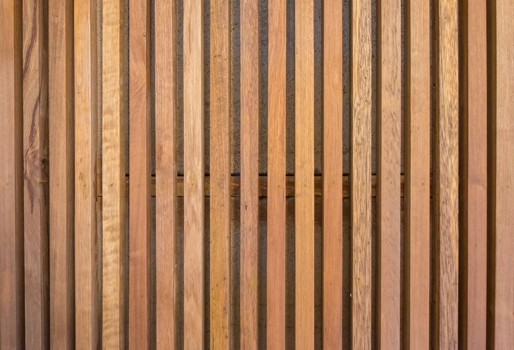 Vertical Wooden Slats, Various Shades of Brown, Creating a Textured Surface — Express Timber Solutions In Long Jetty, NSW