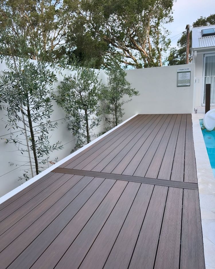 Wooden Deck Next to A Pool, with A White Wall — Express Timber Solutions In Long Jetty, NSW