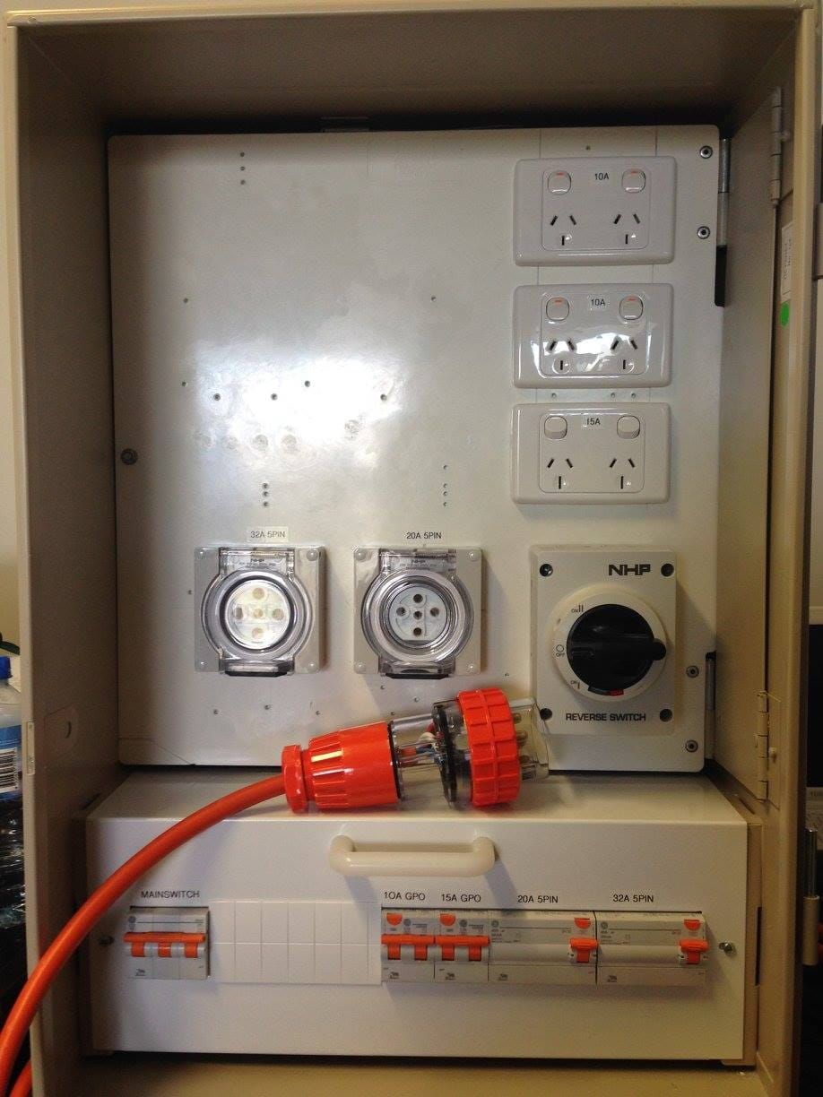 An Orange Cord Is Plugged Into An Electrical Box — Robon Electrical In Cairns, QLD