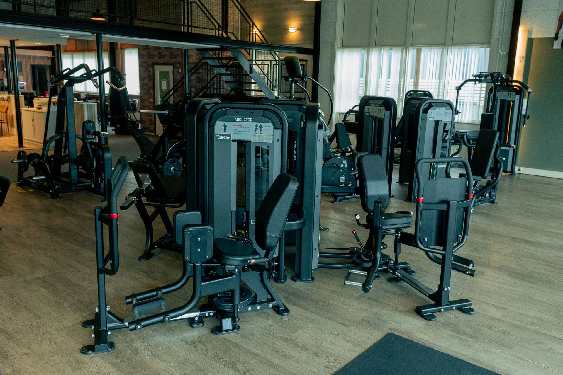 een persoon houdt twee halters vast in een sportschool.