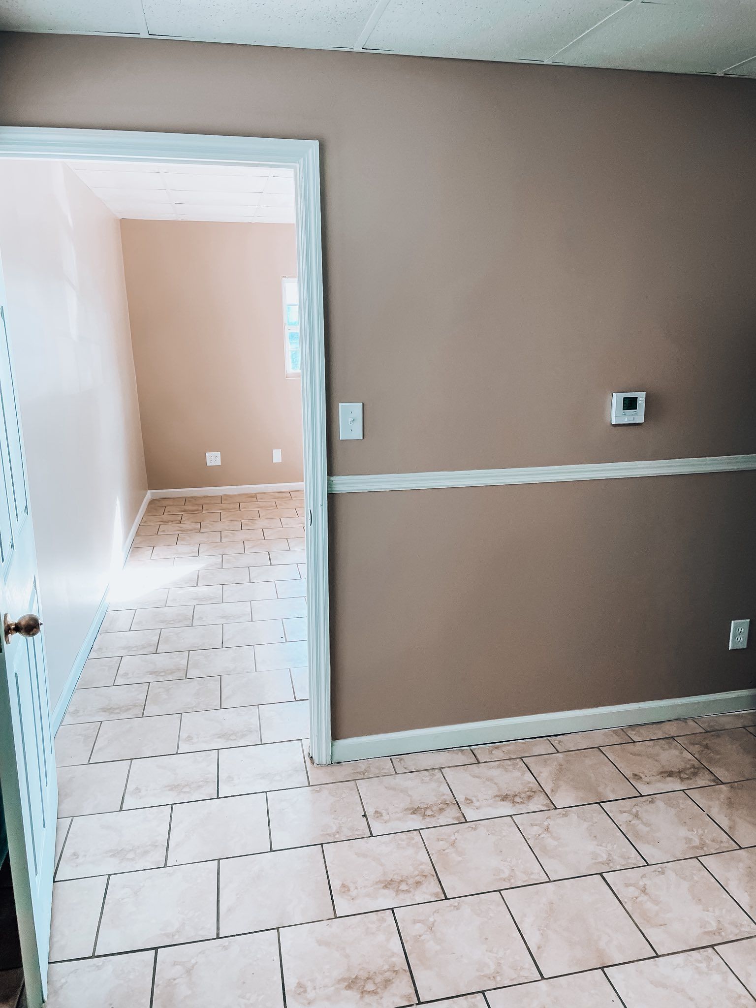 Hands inspecting a document with a magnifying glass and pen on a wooden table