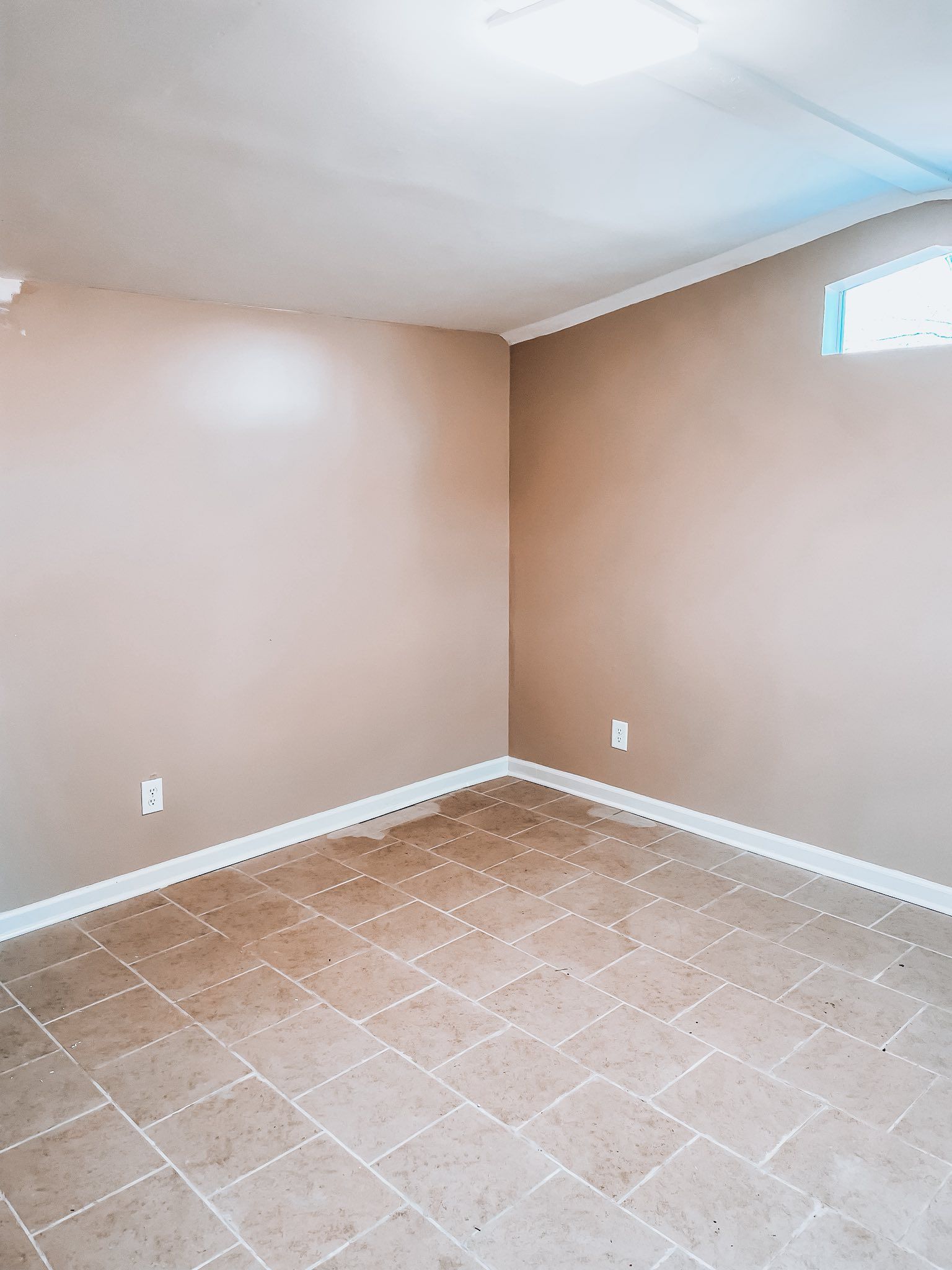 People reviewing a small house model on a desk during a business meeting