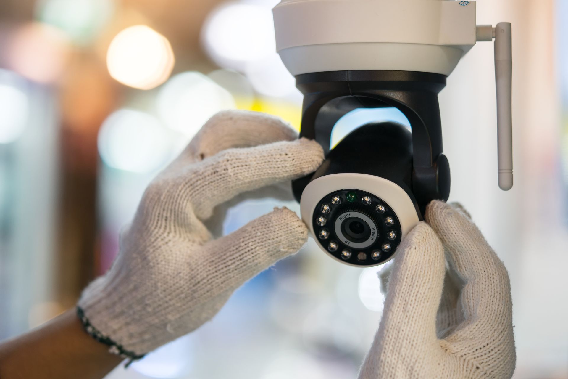A man is installing a security camera.