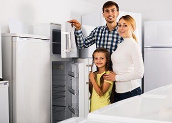 Family Choosing a Refrigerator in a Store — Friendly Finance in Central City, KY