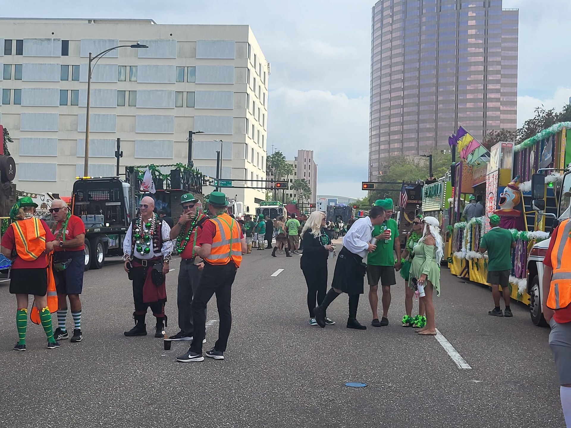 a group of people are standing on the side of a street