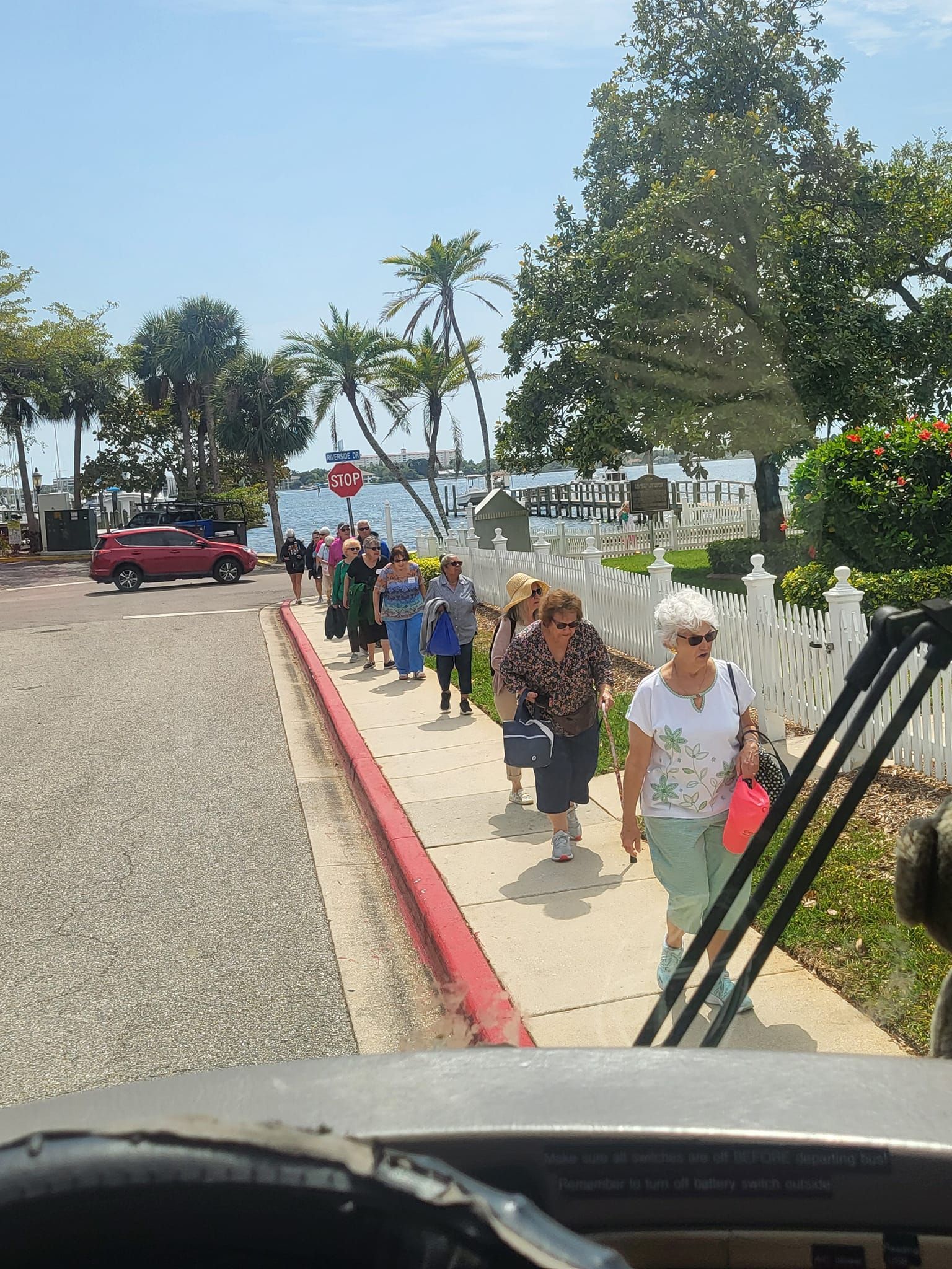 a group of people are walking down a sidewalk