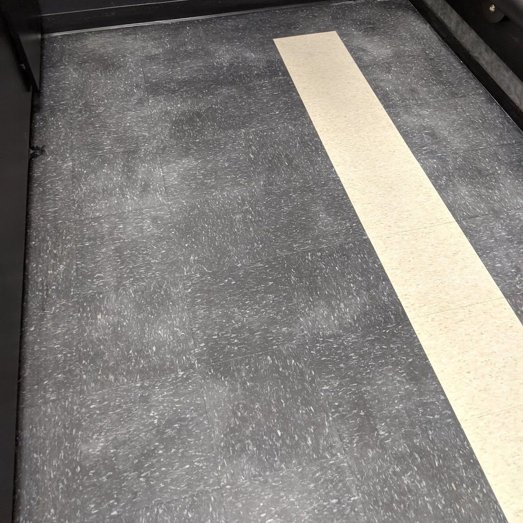 A black floor with a white line on it