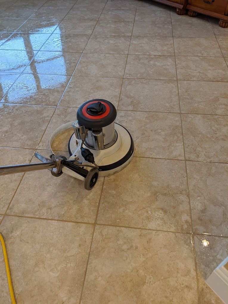 A tile floor is being cleaned with a machine.