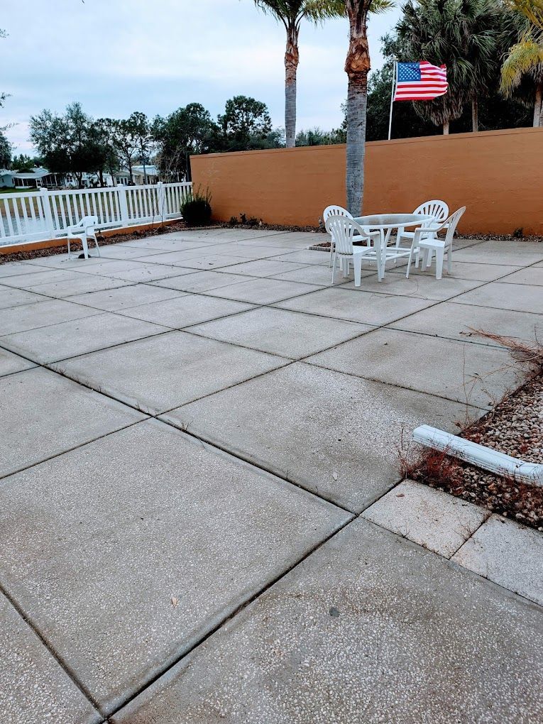 A patio with a table and chairs and an american flag