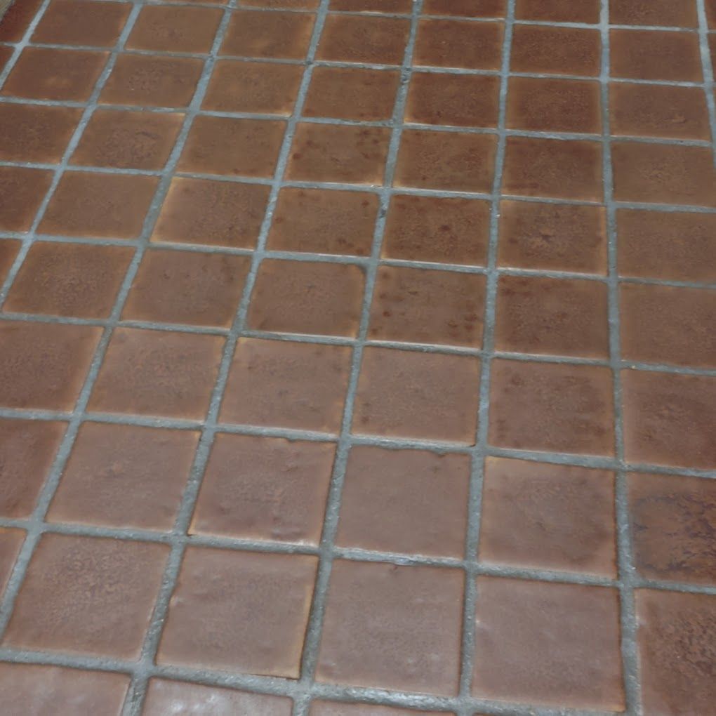 A close up of a brown tile floor