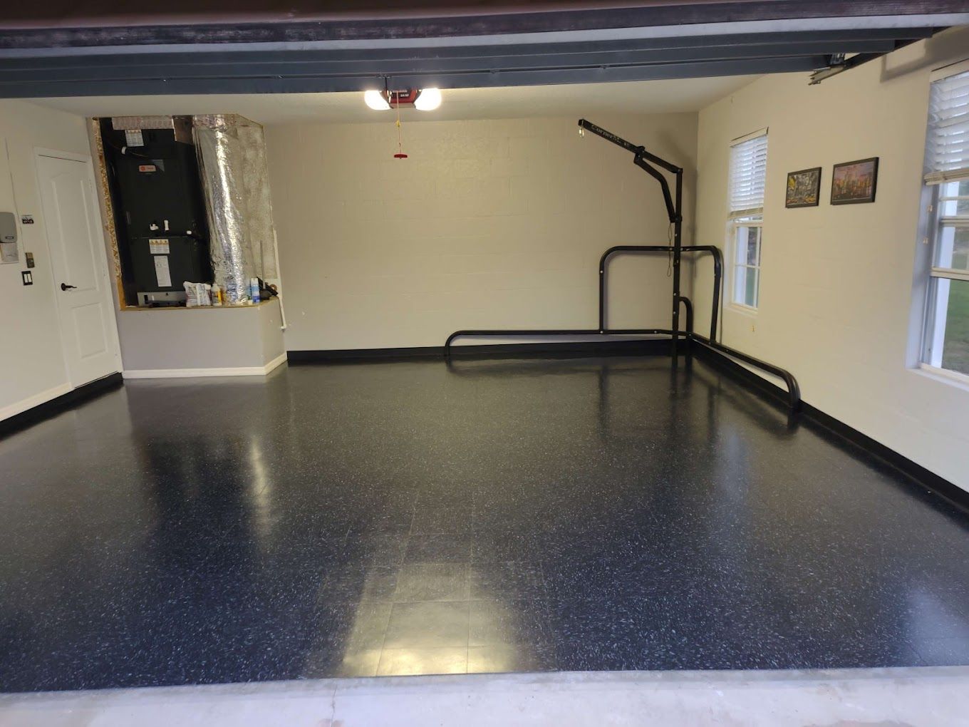 A garage with a black floor and white walls