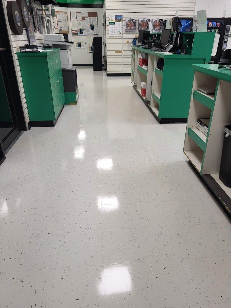 A store with a white floor and green shelves