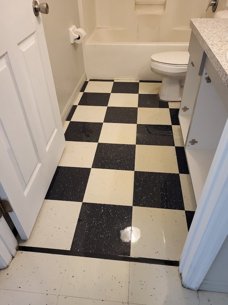 A bathroom with a black and white checkered floor