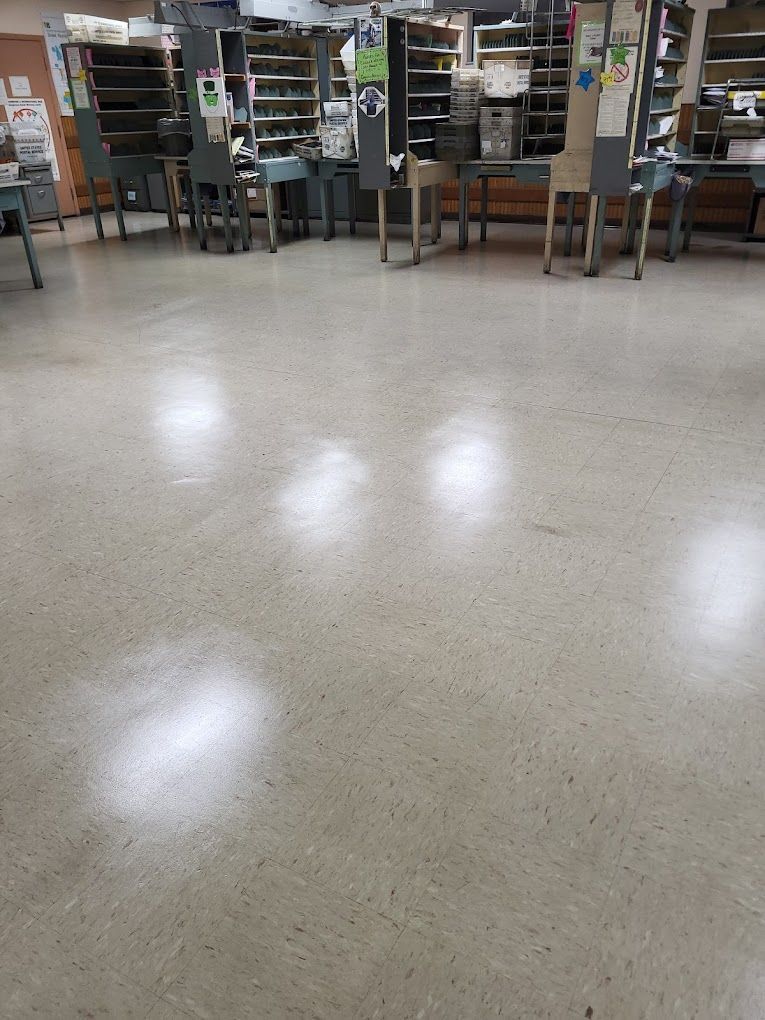 A room with tables and chairs and a shiny floor