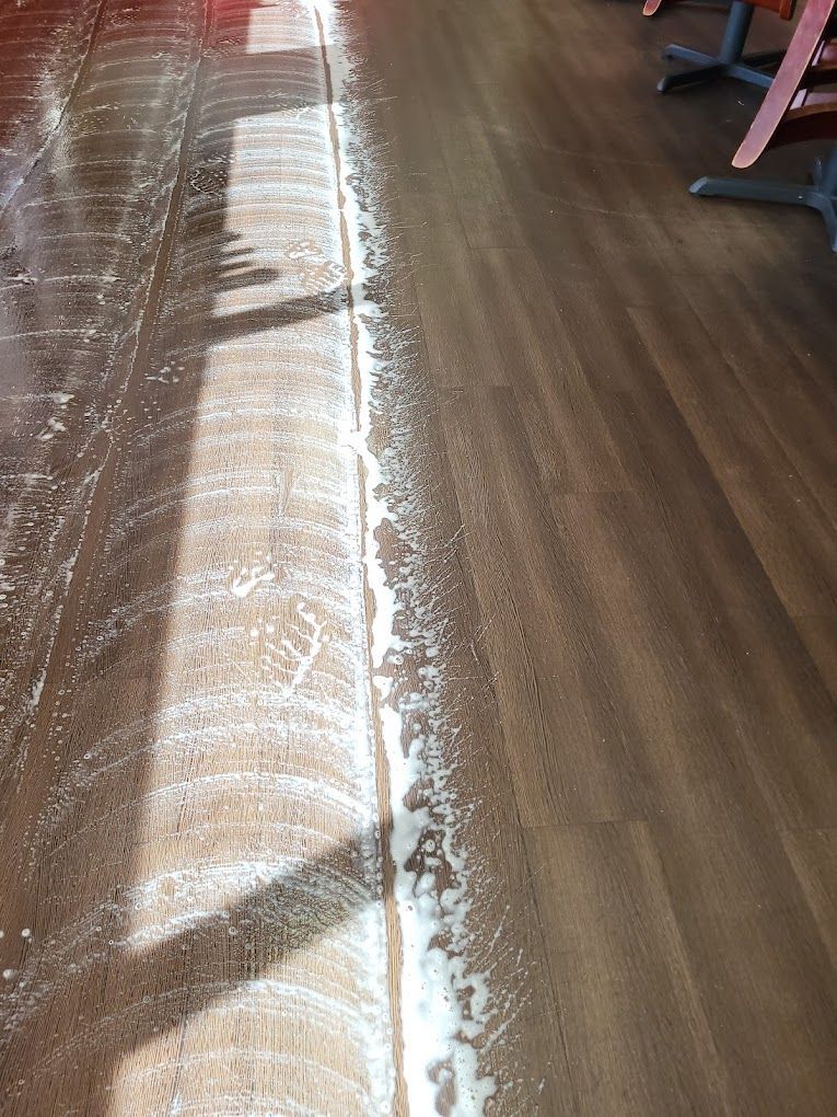 A wooden floor with a white line on it.