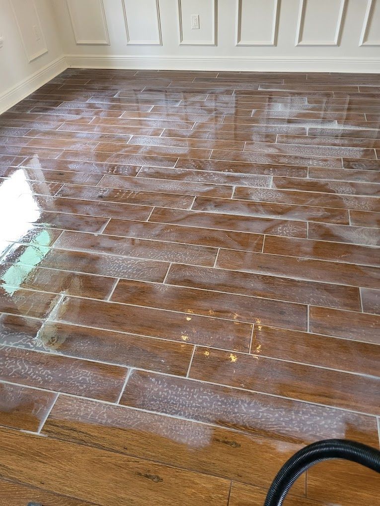 A vacuum cleaner is sitting on a wooden floor in a room.