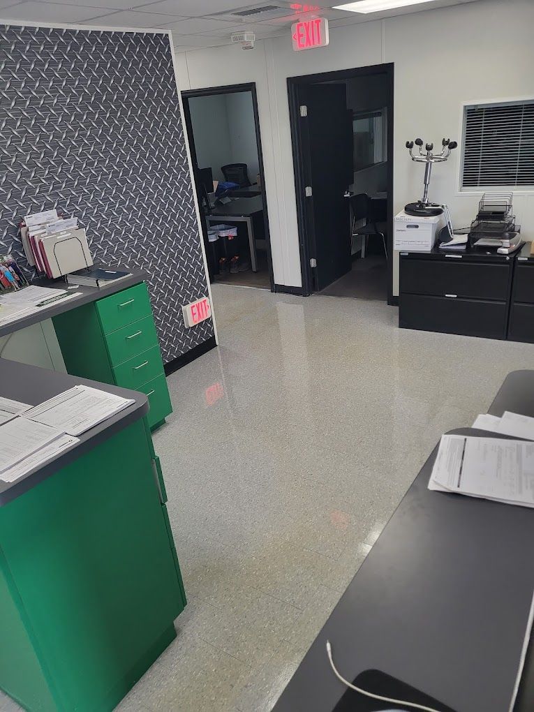A large room with a red exit sign on the wall.