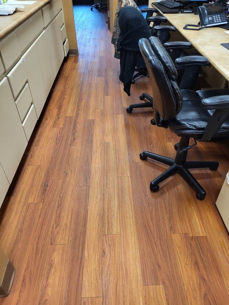 A row of office chairs are lined up in a hallway.