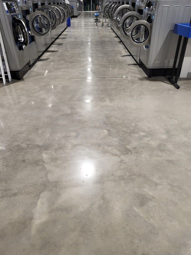 A row of washing machines are lined up in a laundromat.