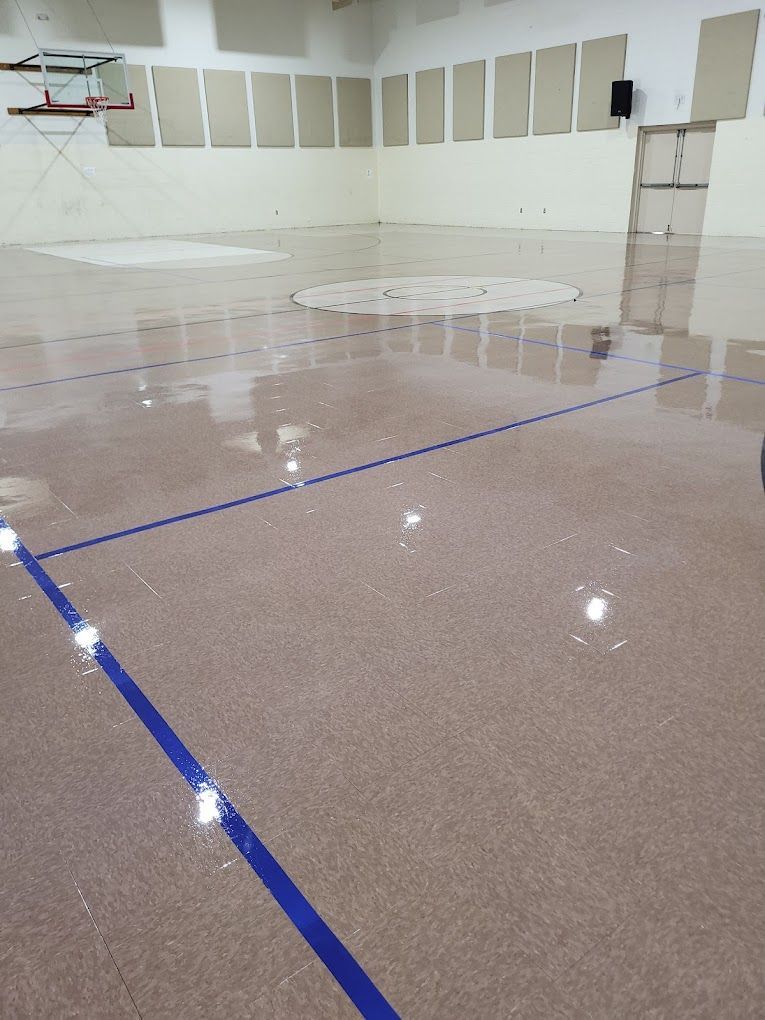 A basketball court with a blue line on the floor